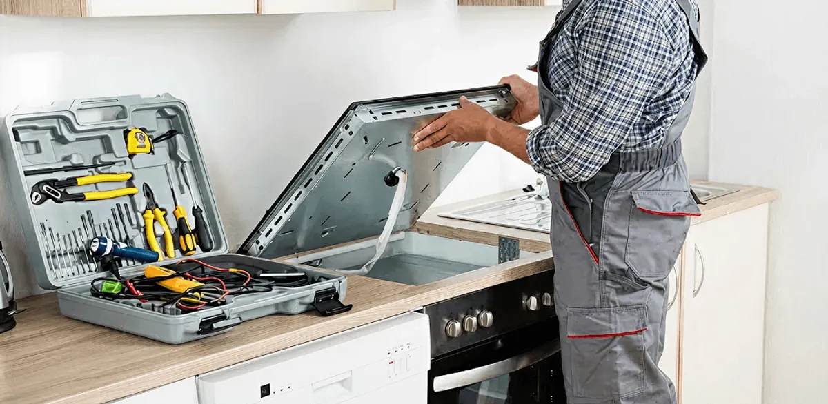 Handyman repairing a cooktop and checking wiring connections in Worcester, MA