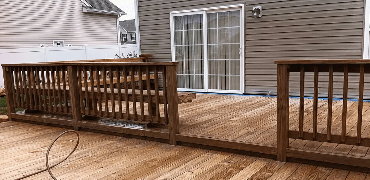 Deck sealing service protecting a backyard wood deck and railings in Worcester, MA
