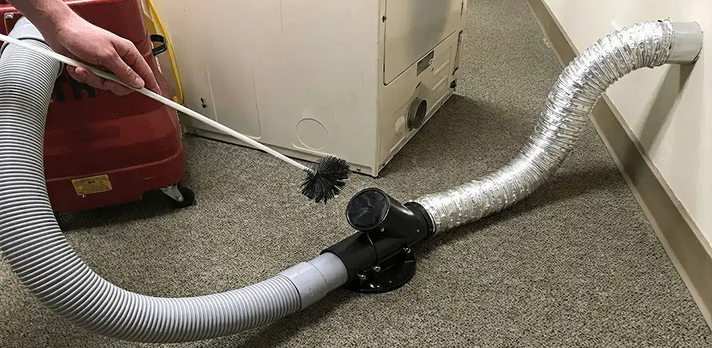 Dryer vent cleaning service removing lint from a dryer duct connection in Worcester, MA