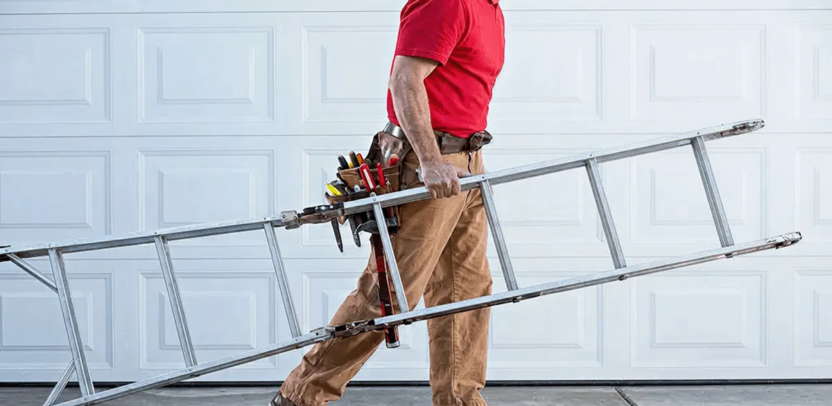 Garage door repair technician arriving with tools and ladder in Worcester, MA