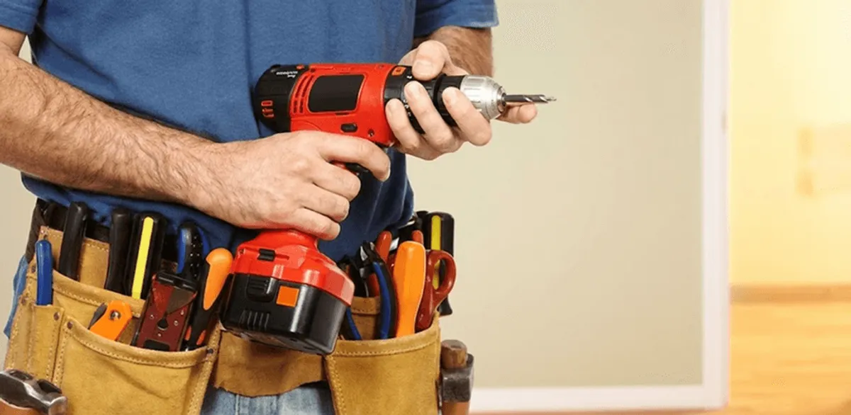 Handyman holding a power drill for home repairs and installations in Worcester, MA