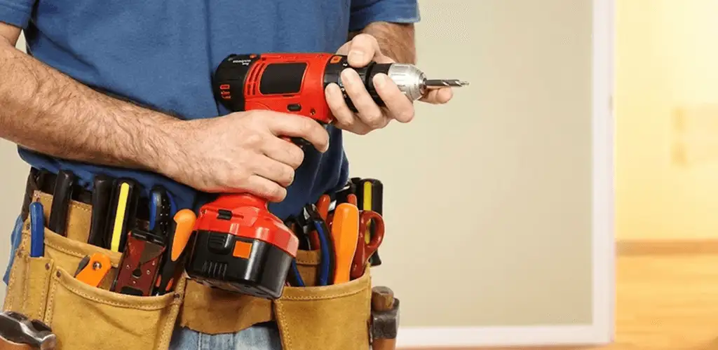 Handyman holding a power drill for home repairs and installations in Worcester, MA