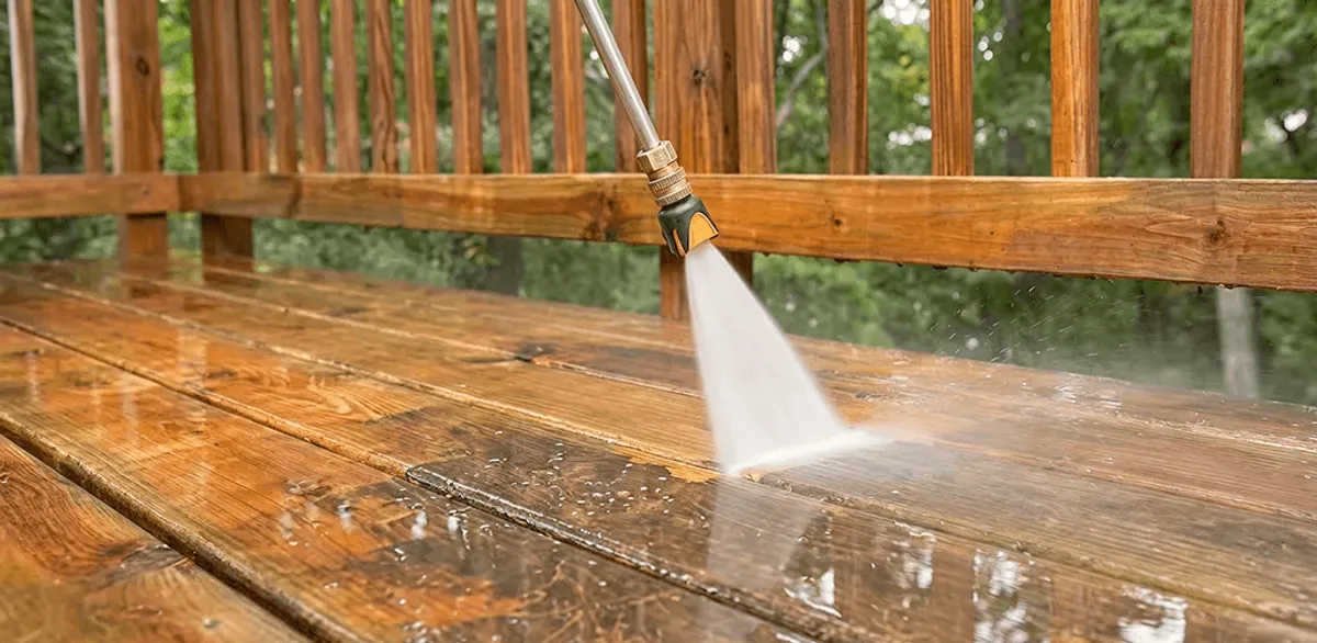 Pressure washing a wood deck to remove dirt and buildup in Worcester, MA