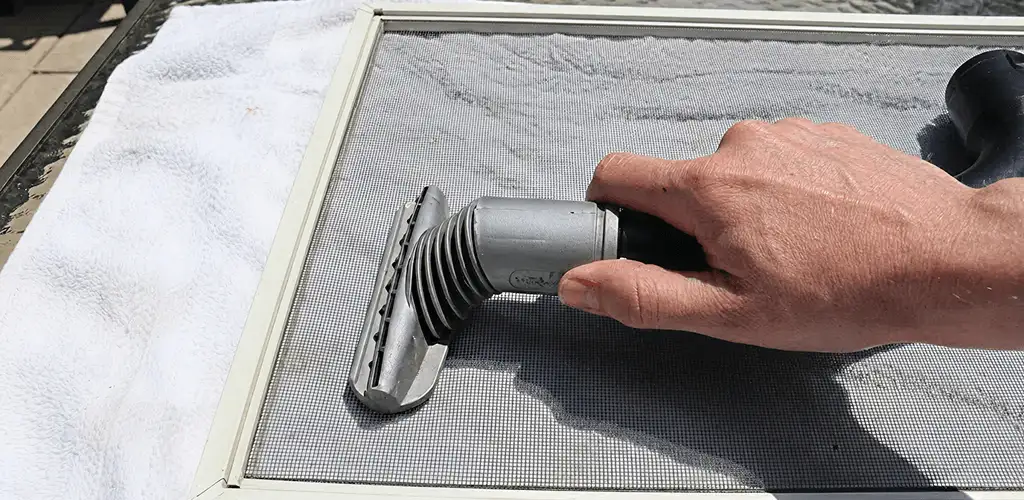 Window screen repair cleaning and fixing a damaged screen mesh in Worcester, MA